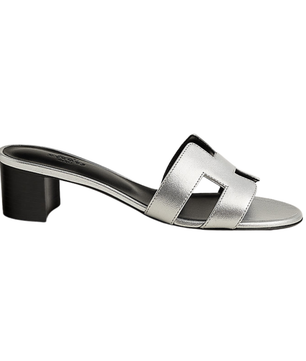 Silver sandal with a black heel on a white background
