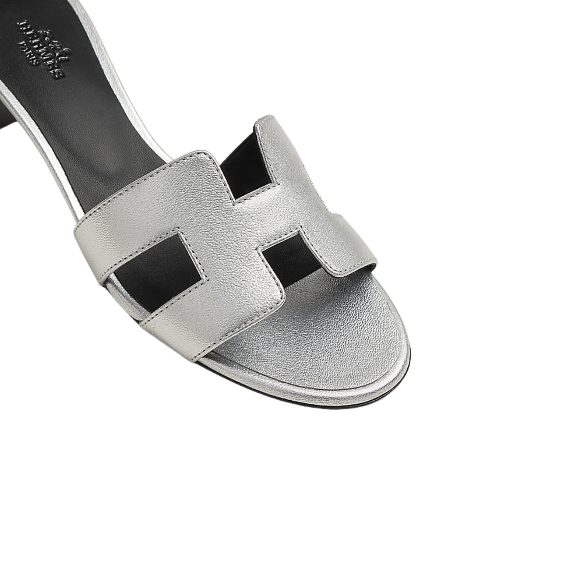 Silver sandal with black straps on a white background