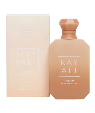 Kay Ali Freedom Musk Santal 34 Eau de Toilette bottle and packaging box, both in a warm peach-beige color, on a solid white background.