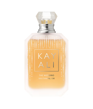 KAY ALI The Wedding Silk Sandal 36 bottle, featuring a clear faceted cap, a silver neck collar, and a frosted glass body filled with a warm golden-yellow liquid. The front label has a gold border with the brand name 'KAY ALI' in gold lettering, and delicate vertical dotted lines decorate the glass.