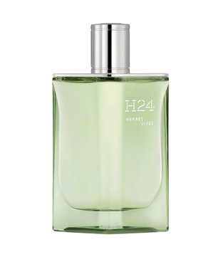 Green perfume bottle with silver cap on a white background