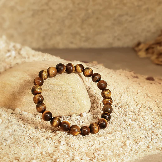 Beaded bracelet on a stone with a sandy background