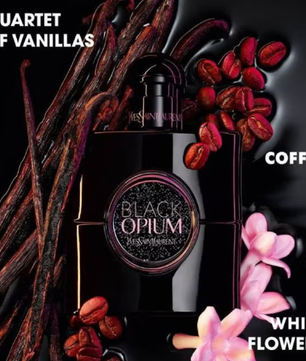 Black Opium perfume bottle with vanilla beans, coffee beans, and white flowers on a dark background.