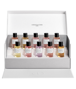 Set of Christian Dior perfume bottles in a display box on a white background
