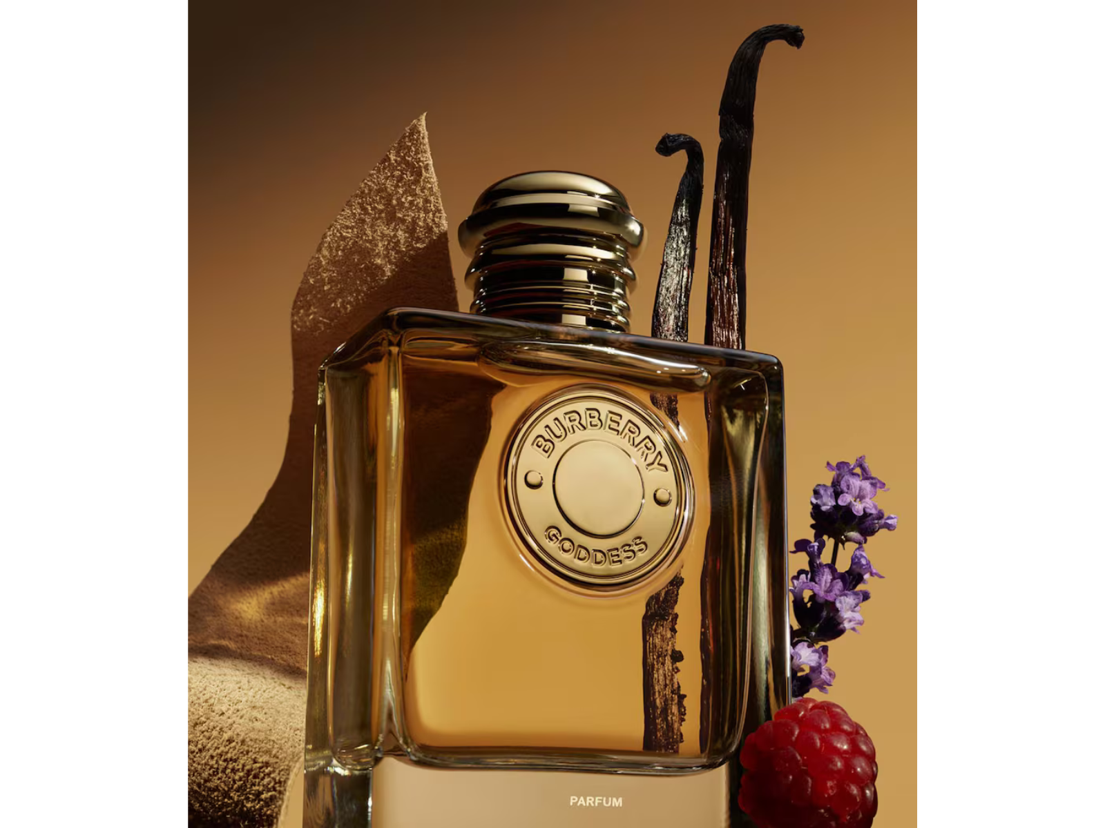 Burberry perfume bottle with vanilla bean, lavender, and raspberry on a warm background