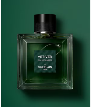 Green Guerlain Vetiver perfume bottle on a green background