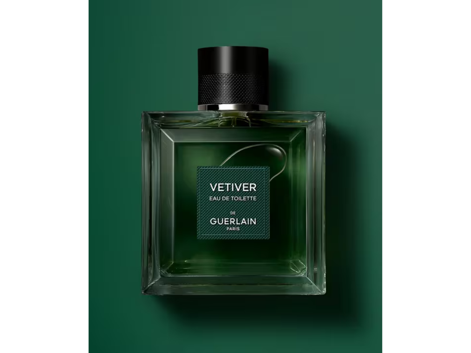 Green Guerlain Vetiver perfume bottle on a green background