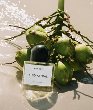 Byredo Alto Astral perfume bottle with coconuts on a beach setting
