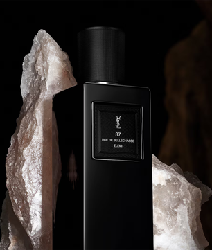 Black perfume bottle with YSL logo against a dark background