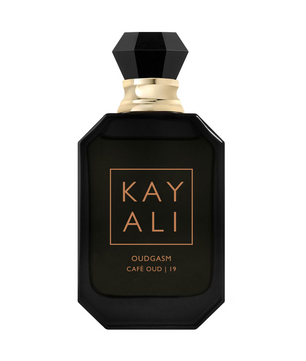 Black perfume bottle with gold accents on a white background