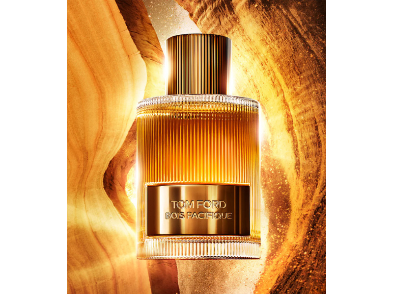 Tom Ford perfume bottle with a gold design on a textured gold background