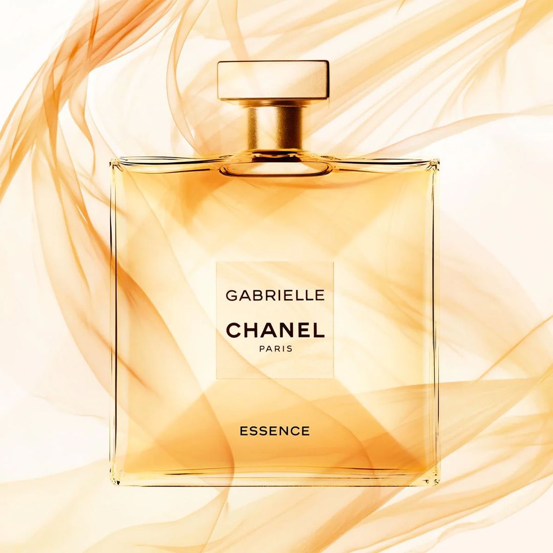 Chanel Gabrielle perfume bottle with gold and white design on a white background
