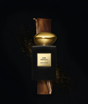 Perfume bottle with gold cap and 'Cuir Zellige' label on a dark background