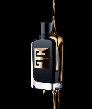 Black perfume bottle with gold accents on a black background