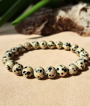 Jewelry bracelet with spotted beads on a sandy surface