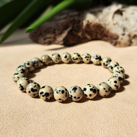 Jewelry bracelet with spotted beads on a sandy surface