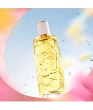 Bottle of yellow liquid with a white cap on a colorful background