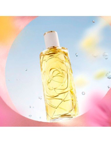 Bottle of yellow liquid with a white cap on a colorful background