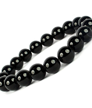 Black beaded bracelet with silver beads on a white background