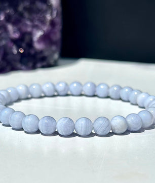Beaded bracelet on a white surface with a dark background