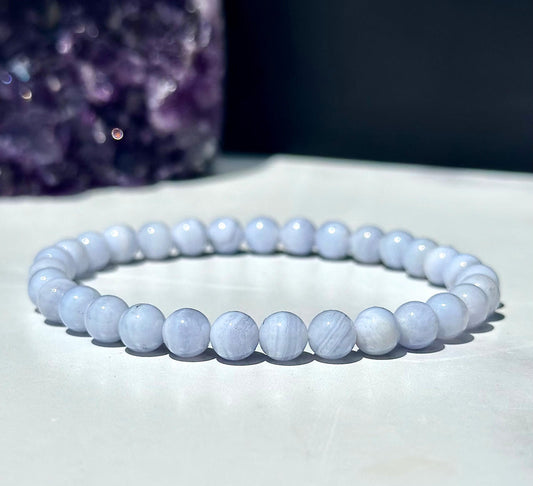 Beaded bracelet on a white surface with a dark background