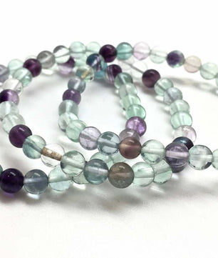 Set of multicolored beaded bracelets on a white background