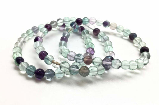 Set of multicolored beaded bracelets on a white background