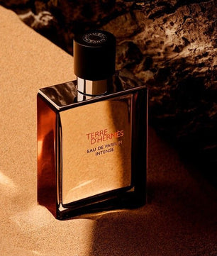 Perfume bottle labeled 'Terre d'Hermes' on a textured surface