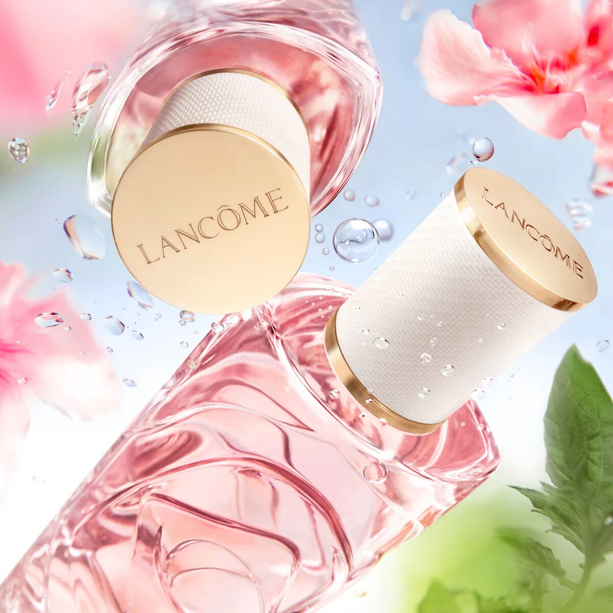 Lancome perfume bottles with pink flowers and water droplets on a light blue background