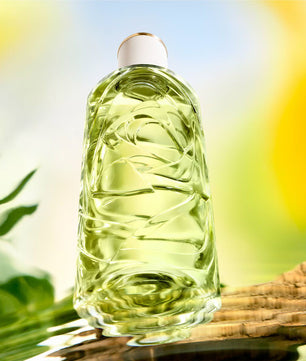 Clear bottle with green liquid on a natural background