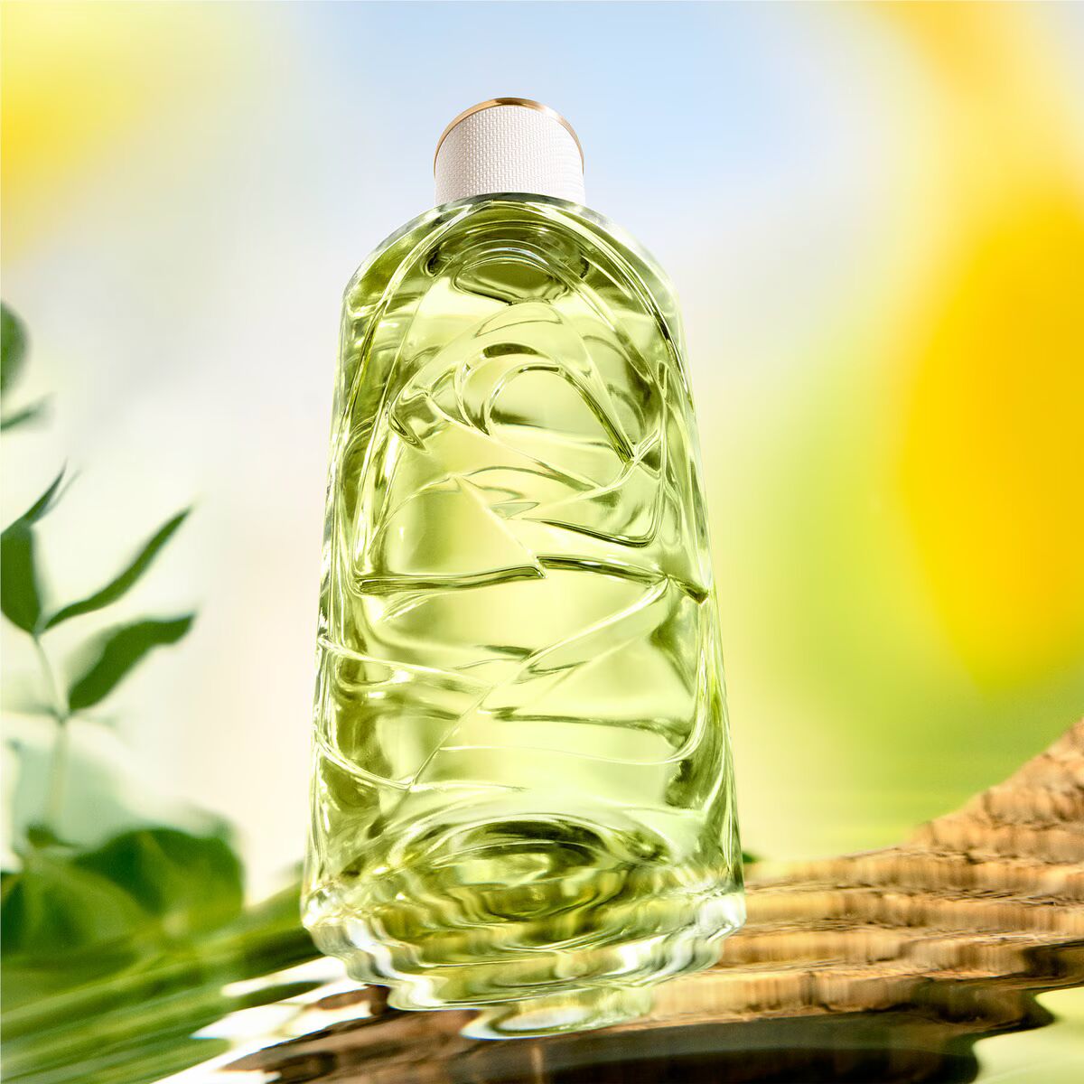 Clear bottle with green liquid on a natural background