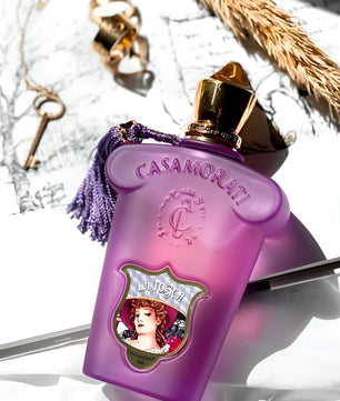 Purple Casamorati perfume bottle with decorative elements on a white background