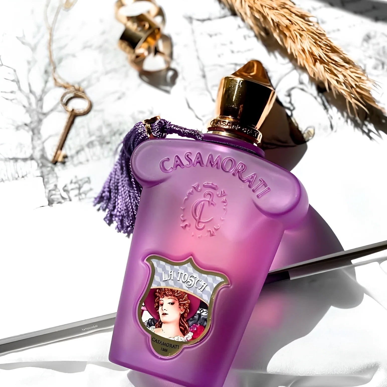 Purple Casamorati perfume bottle with decorative elements on a white background