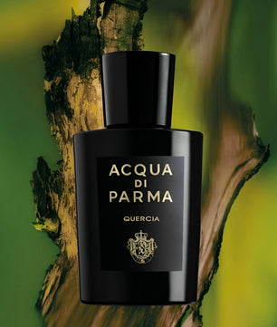 Black Acqua di Parma perfume bottle on a natural background