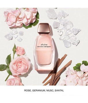 Pink perfume bottle with floral elements on a light background