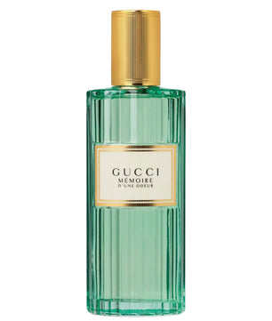 Gucci perfume bottle with gold cap on a white background