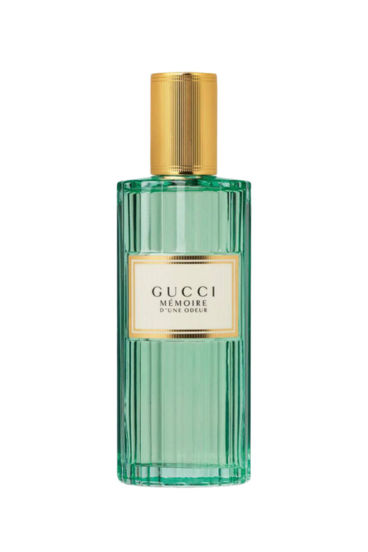 Gucci perfume bottle with gold cap on a white background