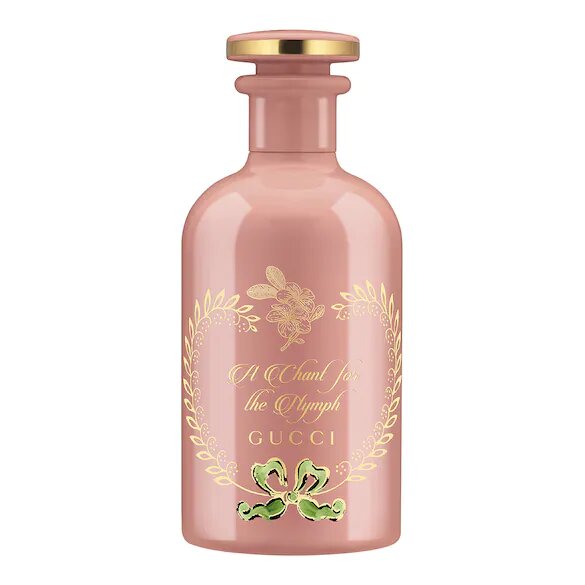 A pink GUCCI Eau De Parfum bottle with a gold cap and floral design around the label.