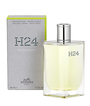Hermes H24 Eau de Toilette bottle and packaging, 100ml. The bottle is transparent with a silver cap, and the packaging is gray and green with 'H24' and 'Eau de Toilette' text.