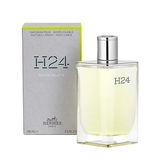 Hermes H24 Eau de Toilette bottle and packaging, 100ml. The bottle is transparent with a silver cap, and the packaging is gray and green with 'H24' and 'Eau de Toilette' text.